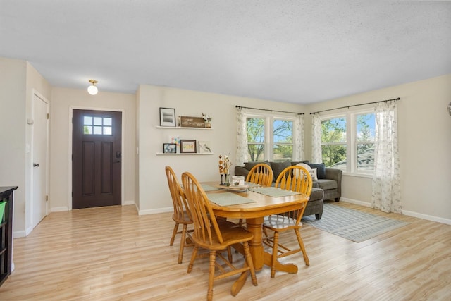 1001 20th St, Minot, ND 58703 - dining space with light wood-type flooring and baseboards