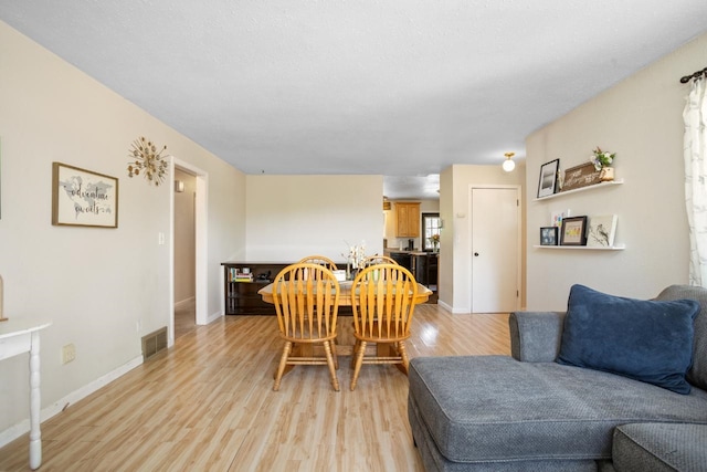 1001 20th St, Minot, ND 58703 - dining room with light wood-style floors and baseboards