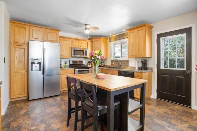 1001 20th St, Minot, ND 58703 - kitchen featuring stainless steel appliances, a sink, butcher block countertops, and stone finish floors
