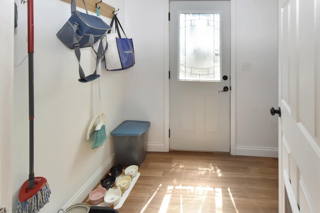 321 6th St, Minot, ND 58703 - doorway to outside with baseboards and light wood-style flooring