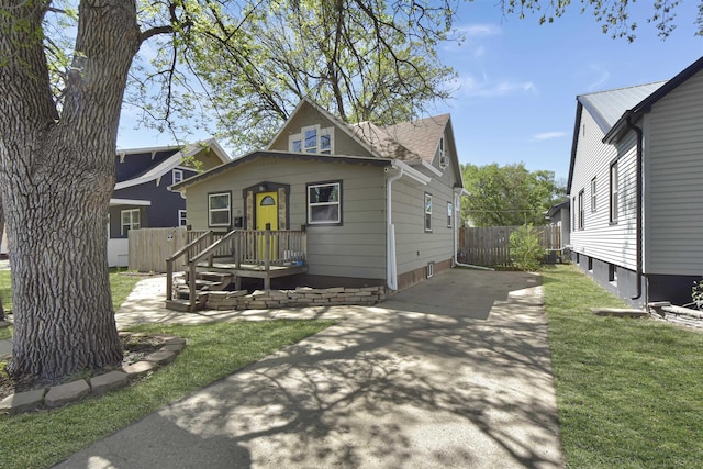 321 6th St, Minot, ND 58703 - bungalow-style home with roof with shingles and driveway