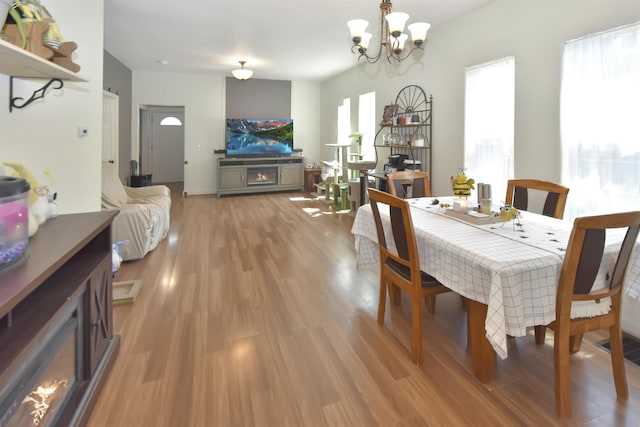 321 6th St, Minot, ND 58703 - dining space featuring light wood-type flooring and a chandelier