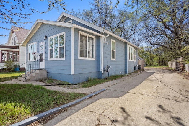 706 E Central Ave, Minot, ND 58701 - view of side of home with fence and driveway