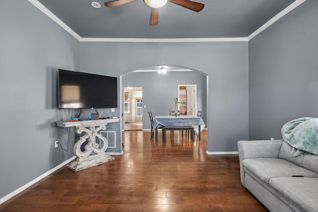 706 E Central Ave, Minot, ND 58701 - living area with arched walkways, a ceiling fan, ornamental molding, wood finished floors, and baseboards