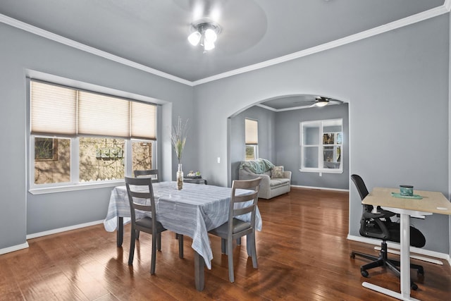706 E Central Ave, Minot, ND 58701 - dining room featuring a ceiling fan, arched walkways, crown molding, baseboards, and wood finished floors