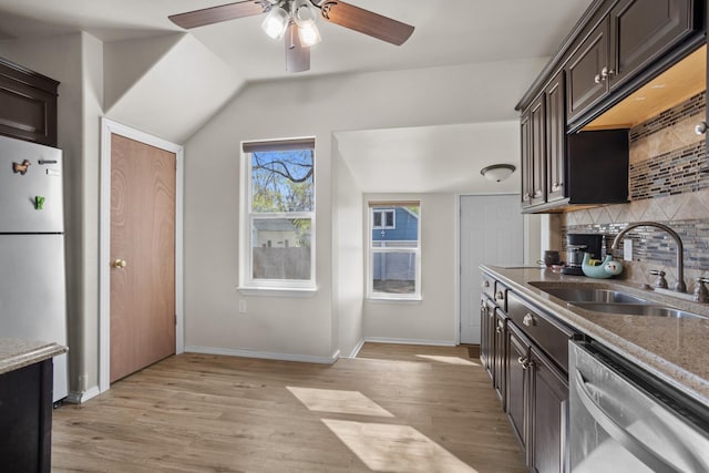 706 E Central Ave, Minot, ND 58701 - kitchen featuring freestanding refrigerator, a sink, stainless steel dishwasher, decorative backsplash, and a ceiling fan