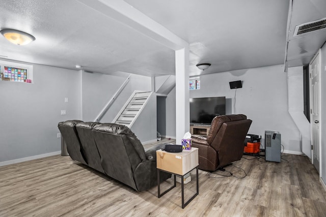 706 E Central Ave, Minot, ND 58701 - living area featuring wood finished floors, stairs, and baseboards