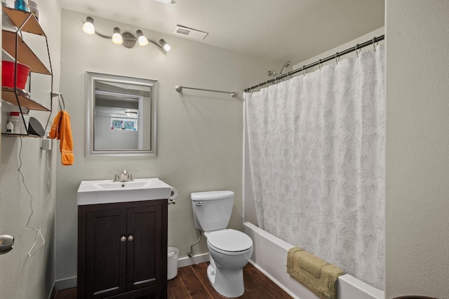 706 E Central Ave, Minot, ND 58701 - full bath with wood finished floors, toilet, vanity, and shower / bath combination with curtain