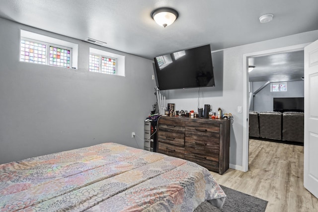 706 E Central Ave, Minot, ND 58701 - bedroom featuring light wood-style floors and baseboards