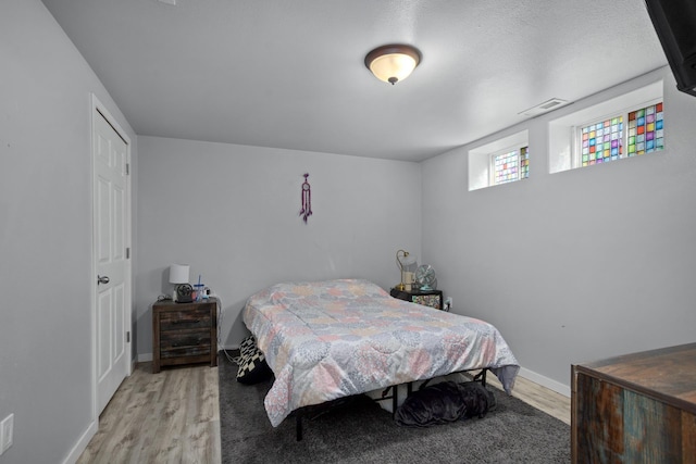 706 E Central Ave, Minot, ND 58701 - bedroom with light wood-style floors and baseboards