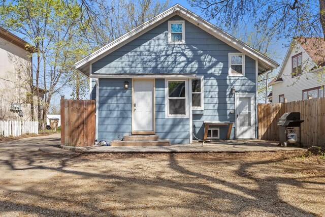 706 E Central Ave, Minot, ND 58701 - rear view of property featuring entry steps and fence