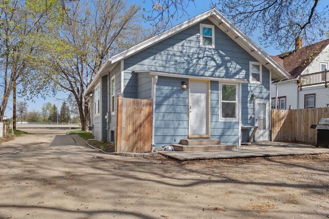 706 E Central Ave, Minot, ND 58701 - view of front of house with entry steps and fence