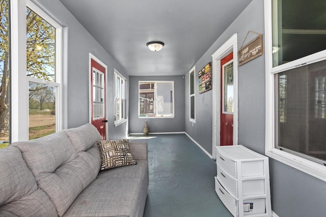706 E Central Ave, Minot, ND 58701 - living area featuring finished concrete floors, healthy amount of natural light, and baseboards