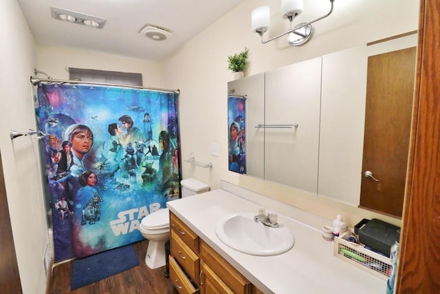 306 Davis St, Burlington, ND 58722 - bathroom with toilet, wood finished floors, vanity, and curtained shower