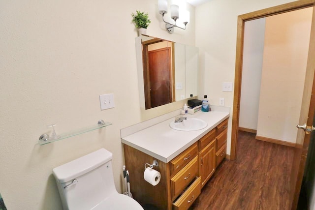 306 Davis St, Burlington, ND 58722 - bathroom with wood finished floors, vanity, toilet, and baseboards