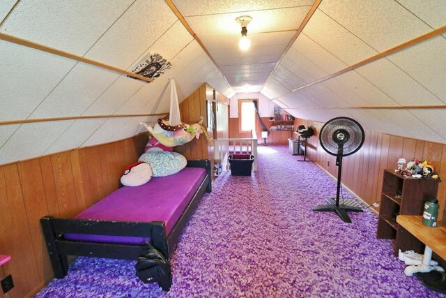 306 Davis St, Burlington, ND 58722 - game room featuring wood walls, carpet, and lofted ceiling
