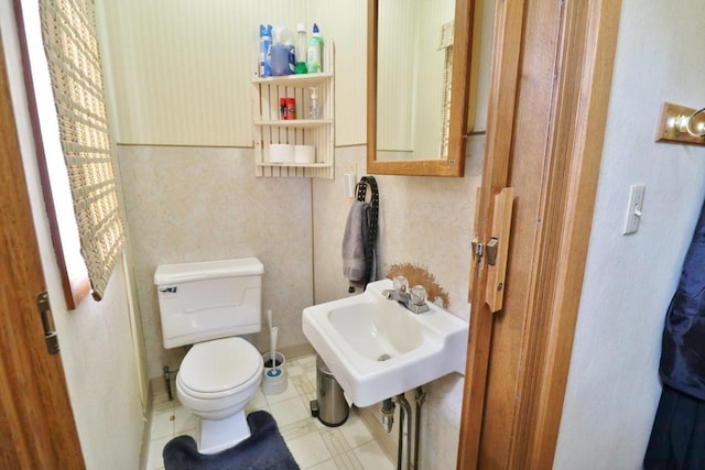 306 Davis St, Burlington, ND 58722 - half bathroom featuring a sink, toilet, and tile patterned floors