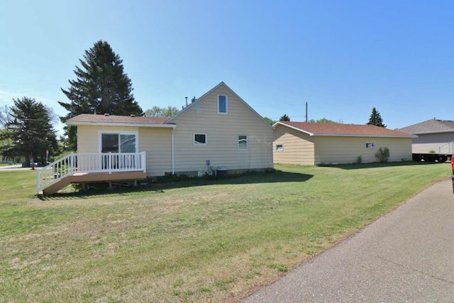 306 Davis St, Burlington, ND 58722 - view of side of property with a lawn and a deck