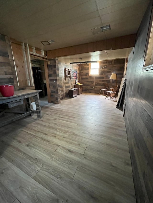 909 NW 10th Ave, Minot, ND 58703 - below grade area featuring wood walls and wood finished floors