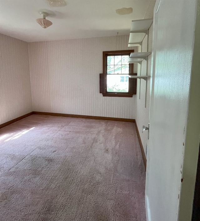 909 NW 10th Ave, Minot, ND 58703 - carpeted empty room featuring baseboards