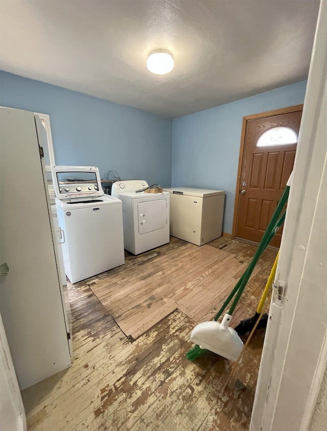 909 NW 10th Ave, Minot, ND 58703 - laundry area with washer and clothes dryer and light wood-type flooring