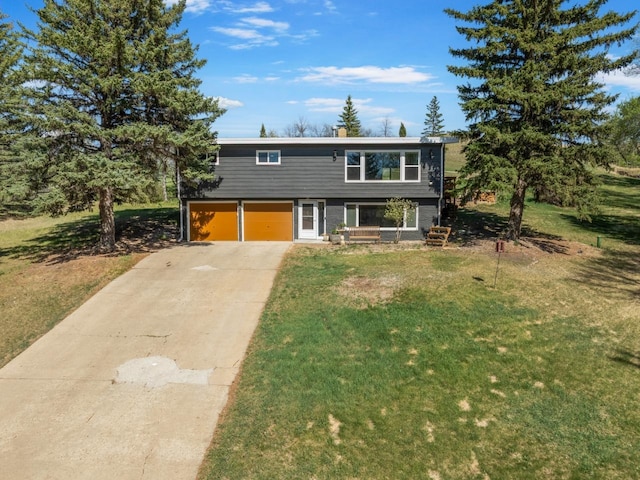 4401 38th St, Minot, ND 58701 - view of front of house with driveway, a front lawn, and an attached garage