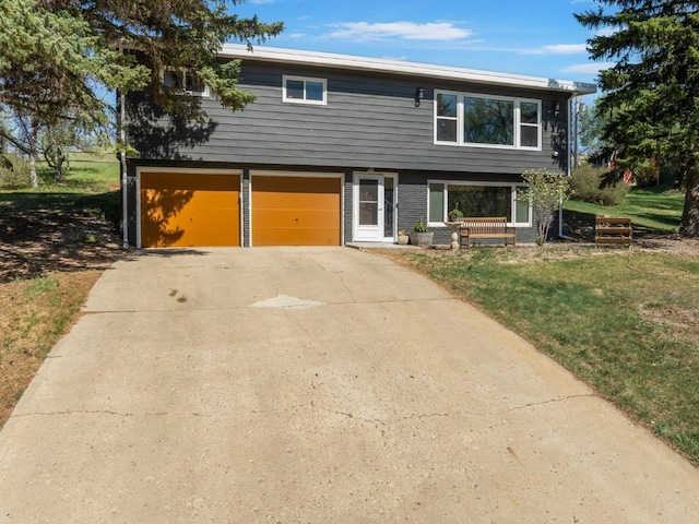 4401 38th St, Minot, ND 58701 - view of front facade with a garage, driveway, a front yard, and brick siding