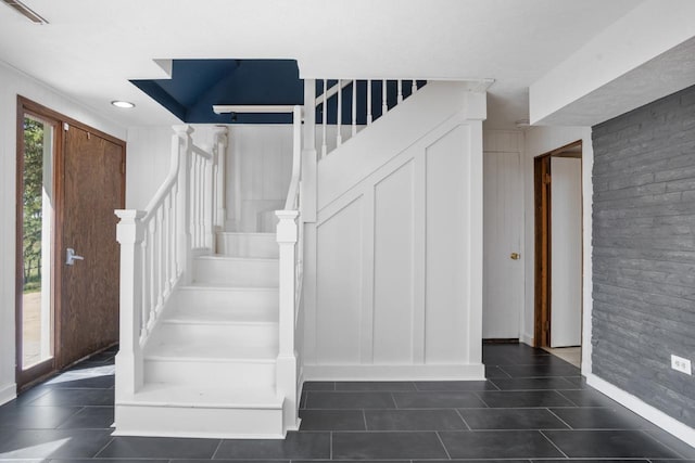 4401 38th St, Minot, ND 58701 - stairway featuring tile patterned flooring and baseboards