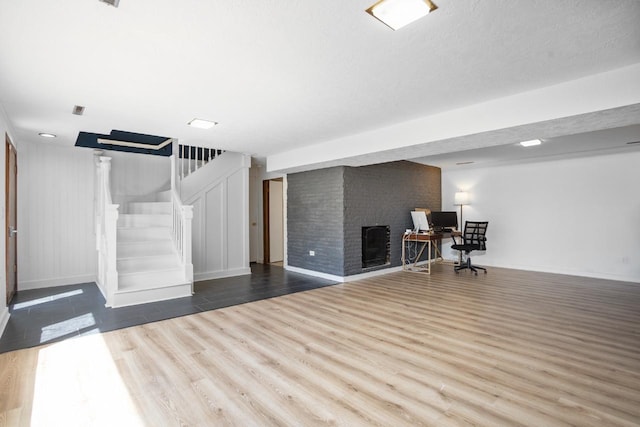 4401 38th St, Minot, ND 58701 - basement with stairway, wood finished floors, a desk, and baseboards