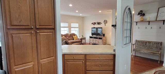 1728 Rivers Edge, Minot, ND 58701 - kitchen with light countertops, recessed lighting, open floor plan, brown cabinets, and light wood-style flooring
