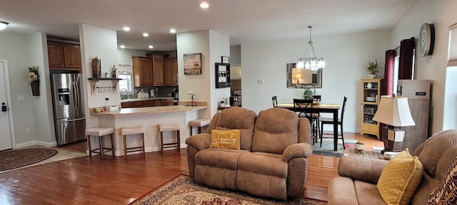 1728 Rivers Edge, Minot, ND 58701 - living room featuring wood finished floors, recessed lighting, and a chandelier