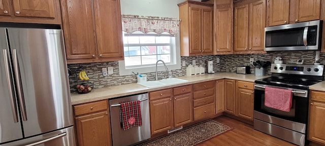 1728 Rivers Edge, Minot, ND 58701 - kitchen featuring stainless steel appliances, a sink, backsplash, and light countertops