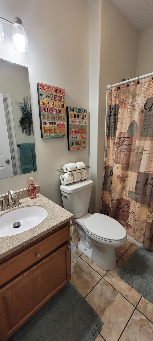 1728 Rivers Edge, Minot, ND 58701 - bathroom with toilet, vanity, tile patterned floors, and curtained shower