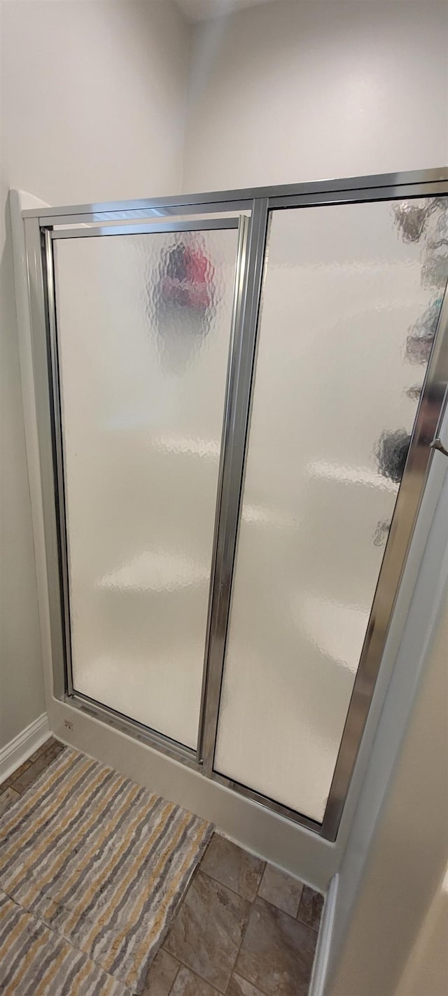 1728 Rivers Edge, Minot, ND 58701 - bathroom with a stall shower and baseboards