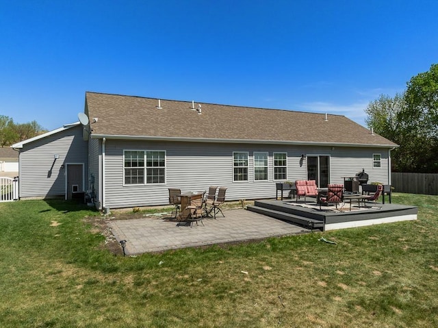 1728 Rivers Edge, Minot, ND 58701 - rear view of house with a patio and roof with shingles