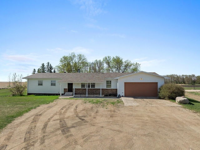 3574 91st St, Mohall, ND 58761 - ranch-style house with dirt driveway, a porch, and an attached garage