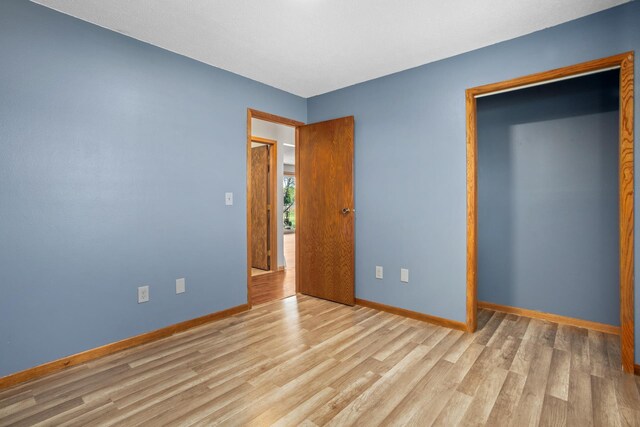 3574 91st St, Mohall, ND 58761 - unfurnished bedroom with baseboards and wood finished floors