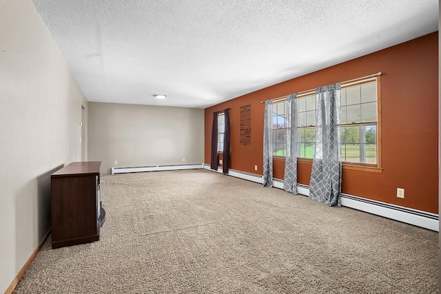 3574 91st St, Mohall, ND 58761 - unfurnished room featuring a baseboard radiator, carpet flooring, a textured ceiling, and healthy amount of natural light