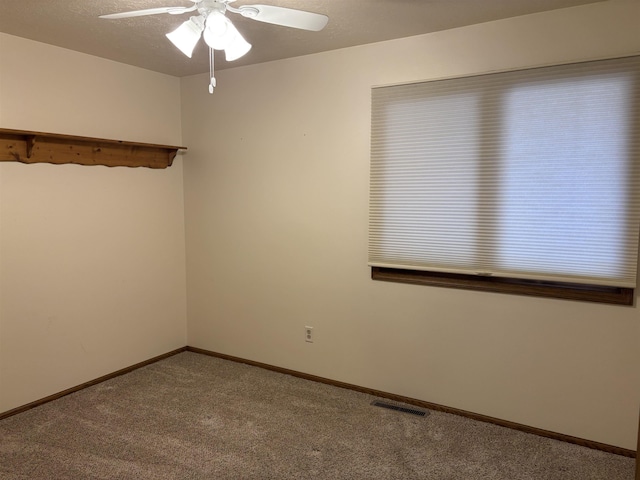2420 8th St Unit 2420, Minot, ND 58703 - unfurnished room featuring carpet, a ceiling fan, and baseboards