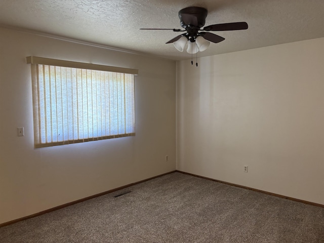 2420 8th St Unit 2420, Minot, ND 58703 - carpeted empty room with a ceiling fan, a textured ceiling, and baseboards