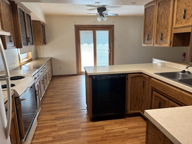 2420 8th St Unit 2420, Minot, ND 58703 - kitchen with black dishwasher, white electric range oven, light wood-style floors, and ceiling fan