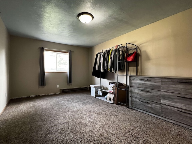 410 6th Ave, Minot, ND 58703 - bedroom featuring carpet floors, baseboard heating, and a textured ceiling