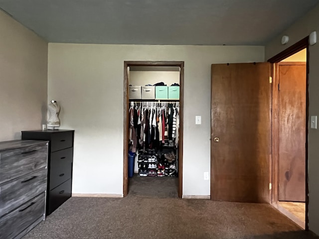 410 6th Ave, Minot, ND 58703 - unfurnished bedroom with carpet floors, a spacious closet, a closet, and baseboards