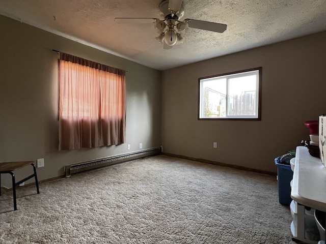 410 6th Ave, Minot, ND 58703 - carpeted spare room with baseboard heating, a ceiling fan, a textured ceiling, and baseboards