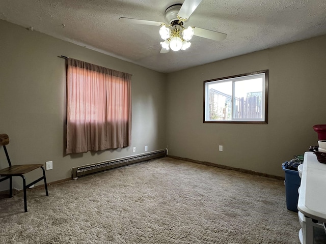 410 6th Ave, Minot, ND 58703 - unfurnished room with baseboard heating, a ceiling fan, a textured ceiling, carpet flooring, and baseboards