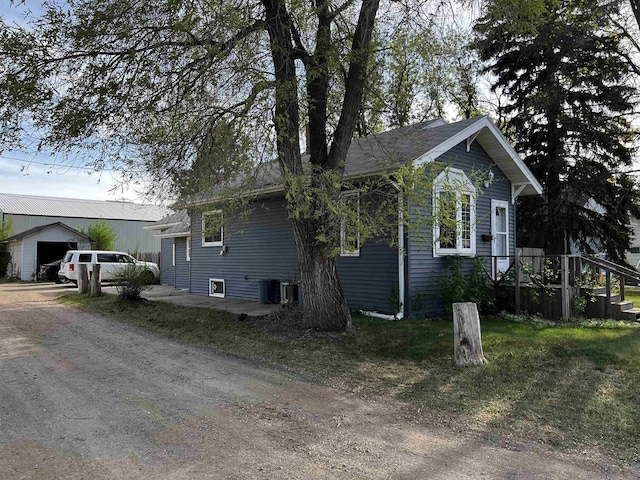 410 6th Ave, Minot, ND 58703 - view of home's exterior featuring an outbuilding and driveway