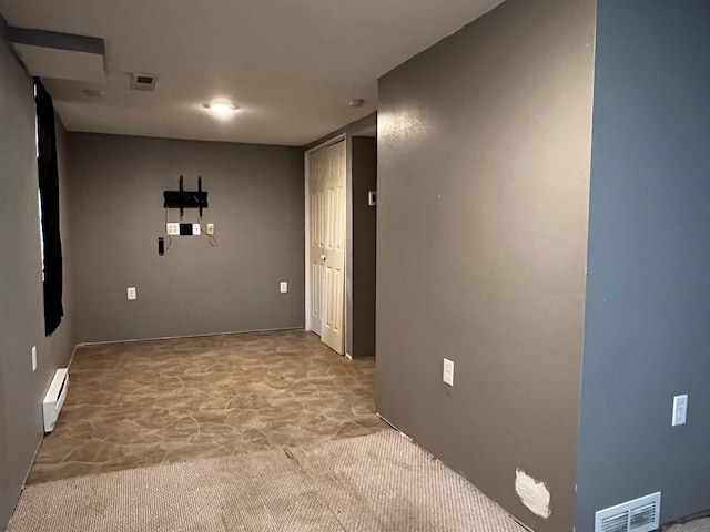 410 6th Ave, Minot, ND 58703 - carpeted spare room with a baseboard heating unit and baseboards