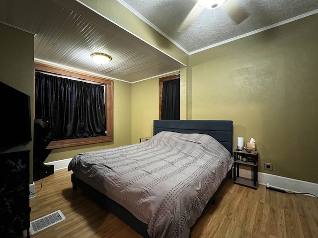 410 6th Ave, Minot, ND 58703 - bedroom featuring wood finished floors, baseboards, and crown molding