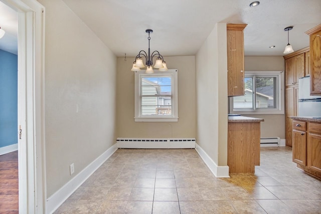 1309 1st St, Minot, ND 58701 - unfurnished dining area with a baseboard radiator, baseboards, a chandelier, and light tile patterned floors