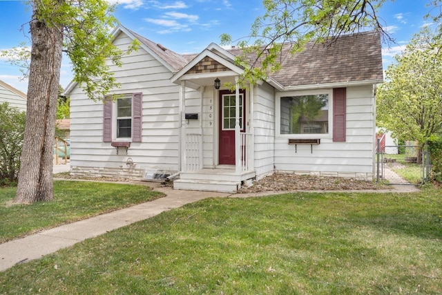1309 1st St, Minot, ND 58701 - view of front of property featuring a shingled roof and a gate